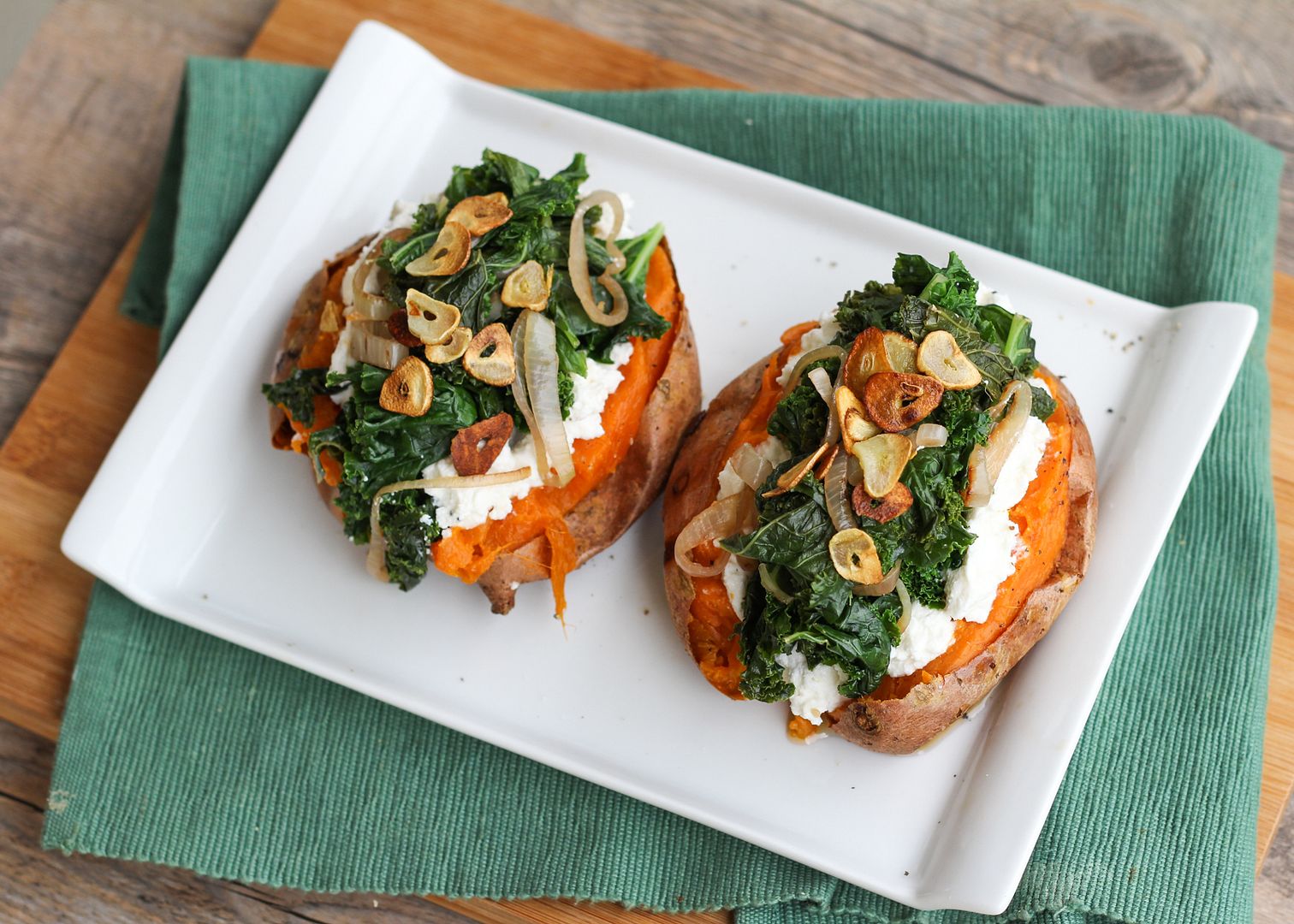 Baked Sweet Potatoes Topped with Ricotta, Goat Cheese, Kale, and Garlic Chips