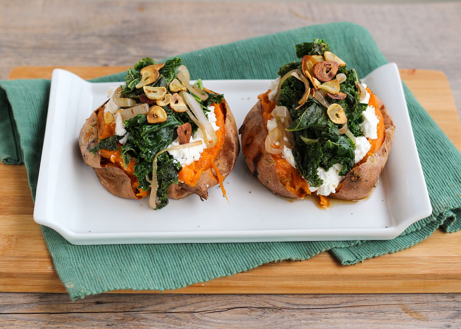Baked Sweet Potatoes Topped with Ricotta, Goat Cheese, Kale, and Garlic Chips